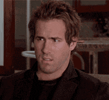 Celebrity gif. Ryan Reynolds looks around with a confused expression, as if searching the room for an answer.