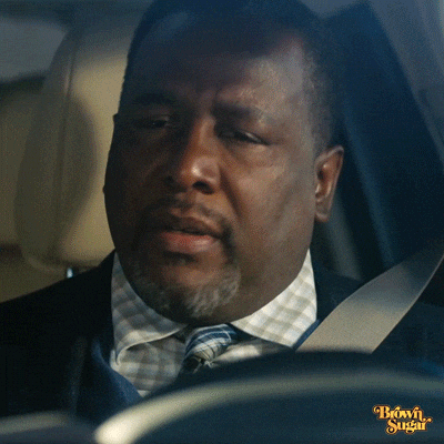 Movie gif. Wendell Pierce as Simon in Brown Sugar sighs, closes his eyes, and rubs his forehead as he sits in the driver's seat of a car.