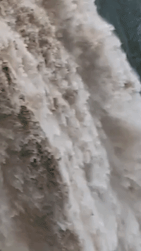 River Rages Over Waterfall After Torrential Rain in New South Wales