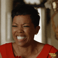 Movie gif. Malinda Williams as Marci in Marry Me For Christmas. She looks down at something with an ecstatic grin on her face and she jumps up and down with joy.