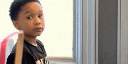 Video gif. A cute little boy sips from a white mug with a judgemental expression on his face. 