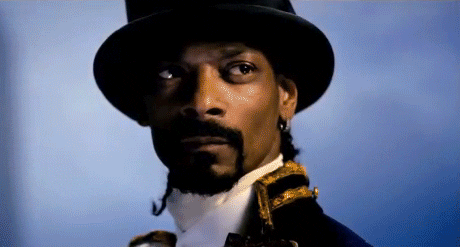 Music video gif. From the video for Gorillaz's "Welcome to the World of the Plastic Beach," in a profile view, Snoop Dogg wears colonial attire and a black top hat, nodding and turning his head to his shoulder.
