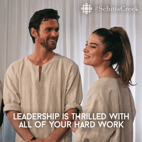Schitt's Creek gif. Kevin McGarry as Citrus smiles kindly at Annie Murphy as Alexis, who appears gracious as he says, "leadership is thrilled with all of your hard work." 