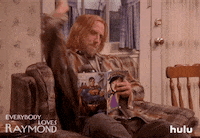 TV gif. Chris Elliot as Peter in Everybody Loves Raymond extends his arm out then pulls it back and mouths the sound Boom as if he just shot a gun.