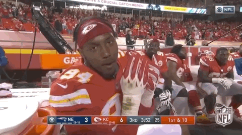 Sports gif. Vidauntae Charlton looks towards and pretends to chomp down on a taco as he sits on the sidelines.