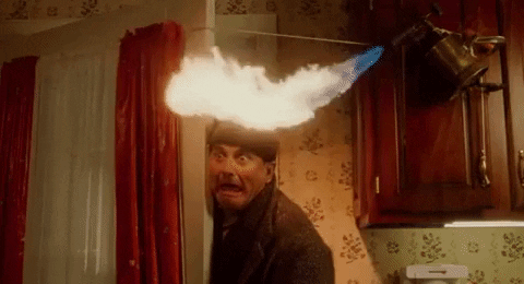 Movie gif. Screaming in terror, Joe Pesci playing Harry in Home Alone stands in a bobby-trapped doorway while a blow torch burns his hat.