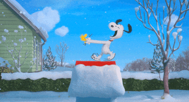 Peanuts gif. Snow falls down as Snoopy dances and hops joyously on top of the doghouse and Woodstock zips around underneath him.