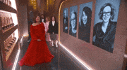Oscars 2024 GIF. Ariana Grande, Cynthia Ervo, Billie Eilish, and Finneas try to scooch by a presenter backstage at the Oscars but are adorably obvious about it. Eilish leads the charge, doing a couple quick side steps in a failed attempt to not distract the camera or presenter.