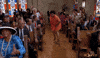 TV gif. A scene in a black church where everyone is dancing and vibing. A woman is in the center aisle and is sweeping the floor with her handkerchief, as they all shout with praises and blessings. 
