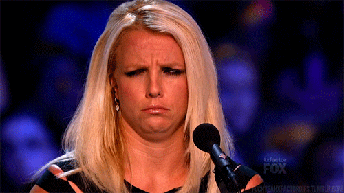 Celebrity gif. Britney Spears furrows her brow and shifts her eyes in confusion as if to say, “huh?”