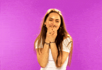 Celebrity gif. Jasmine Thompson covers her mouth and places her hands under her chin as if grateful. Text bounces on the pink background, "Aww."