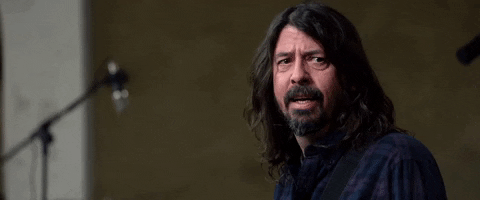 Celebrity gif. Dave Grohl sees something and turns away while rolling his eyes heavily.