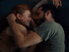 Movie gif. Sadie Sink as Her and Dylan O'Brien as Him in All Too Well lie facing each other as they caress each others faces with affection on a loop.