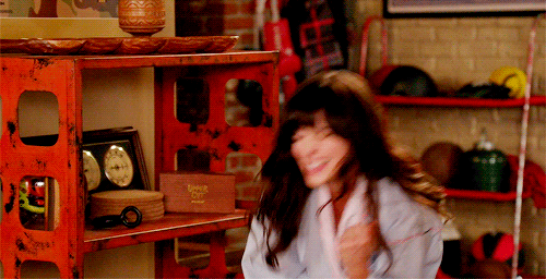 TV gif. Zooey Deschanel as Jessica in New Girl gives an energetic fist pump as she cheers excitedly. 
