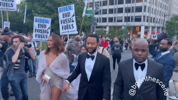 John Legend & Chrissy Teigen Pass Climate Protests