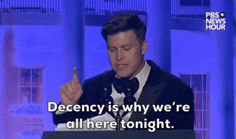 Video gif. Saturday Night Live's Colin Jost stands at a podium at the 2024 White House Correspondents' Dinner and delivers a sincere, serious statement. He says "Decency is why we're all here tonight," as he looks around the room with a serious expression.