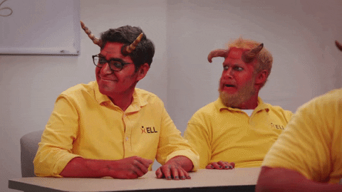 TV gif. Craig Rowin as Claude and Henry Zebrowski as Gary in Your Pretty Face is Going to Hell. Both of them are sitting at a table and they clap eagerly after hearing good news.