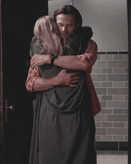 TV gif. Jared Padalecki as Sam in Supernatural. He hugs a woman tightly as he squeezes his eyes closed.