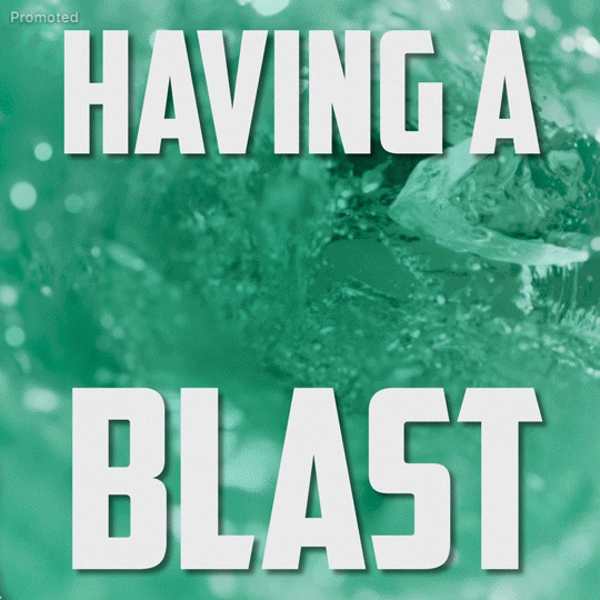 Sponsored gif. Two Mountain Dew Baja Blast soda bottles fly in from the left and right and land side by side in the middle. The background is a swirling teal whirlpool of Baja Blast. Text, "Having a Blast."