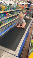 Baby Rides Grocery Conveyer Belt