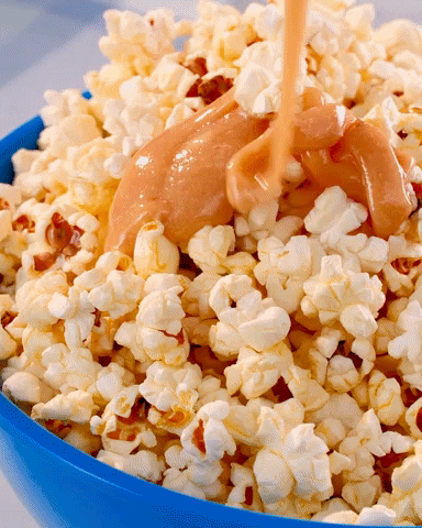 PopcornCentral giphyupload yummy popcorn caramel GIF
