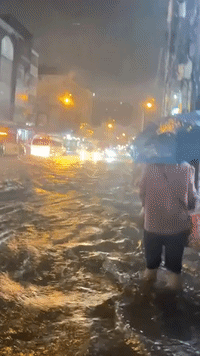People Wade Through Knee-High Water in Bangkok as Heavy Rain Inundates Thailand