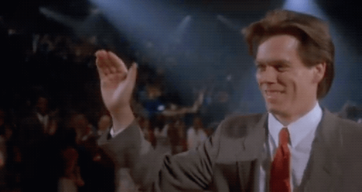 Movie gif. Kevin Bacon as Jimmy in The Air Up There stands giving high fives to endless basketball players in blue jerseys. 