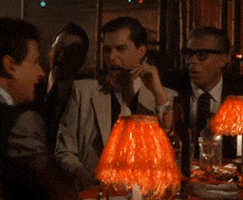 Movie gif. Ray Liotta as Henry Hill in Goodfellas laughs heartily holding a cigarette, laughs heartily grabbing his brow, laughs heartily in his seat, laughs heartily with his hands across his chest, laughs heartily eyes wide gasping for air. 