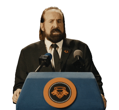 Sponsored sticker gif. Actor Peter Stormare speaks into microphones at a podium. Text reads, "Kick ass."