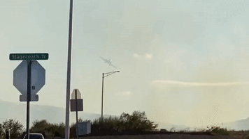 Plane Swoops to Drop Fire Retardant on Arizona Brushfire