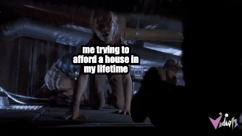Movie gif. From Jurassic Park, Ariana Richards, as Lex labeled “me trying to afford a house in my lifetime,” attempts to crawl across a ceiling as a raptor labeled “inflation” emerges from below, knocking her into an air duct as she screams in terror.
