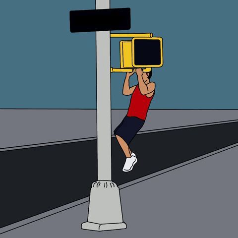 Man doing pull-ups at a crosswalk 