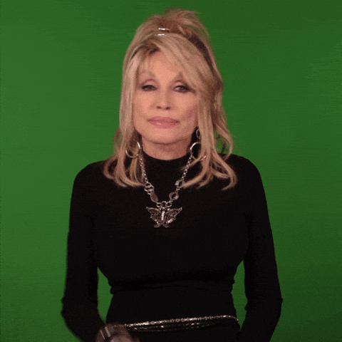 Celebrity gif. Dolly Parton shakes her head and wags her finger as if saying no way. 