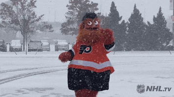 Sports gif. Gritty, the Philly Flyer mascot, jumps around in a snowy parking lot, trying to catch snowflakes and checking his hands to see if he caught any.