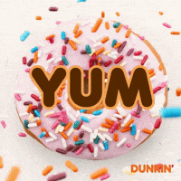 Sponsored gif. Colorful sprinkles rain down on top of a pink frosted donut. Text over the donut reads, “Yum.”