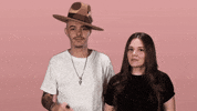 Celebrity gif. Pop duo Jesse and Joy smile and give us an encouraging two thumbs up.