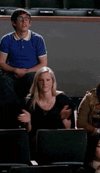 TV gif. Heather Morris as Brittany in Glee. She stands up and starts clapping heavily, giving the person a standing ovation and fist pumping in the air.
