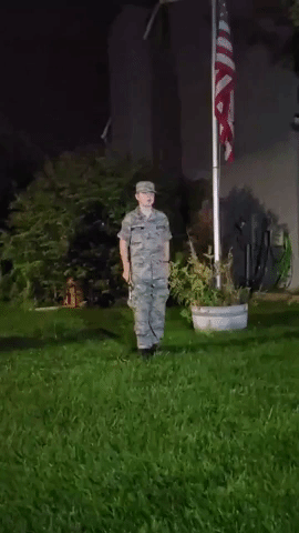 Teenage Boy Plays 'Taps' With Flag at Half-Mast to Honor US Personnel Killed in Kabul Attacks