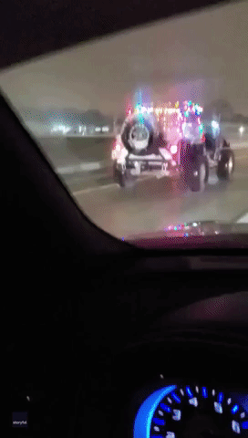 Rudolph Lights the Way for Santa’s Jeep on Indiana Interstate