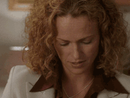 Video gif. Woman looks up slowly, sarcastically saying, "Really?"