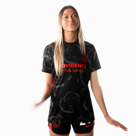 Sports gif. Kelli Hubly from the Portland Thorns tilts her head and smiles at us as she waves. 