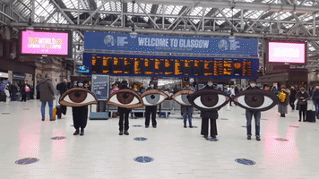 'All Eyes On You': Climate Activists Hold COP26 Demonstration at Glasgow Station