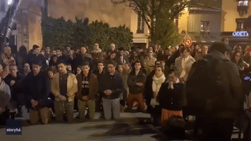 Parisians Gather in Song as Notre Dame Burns