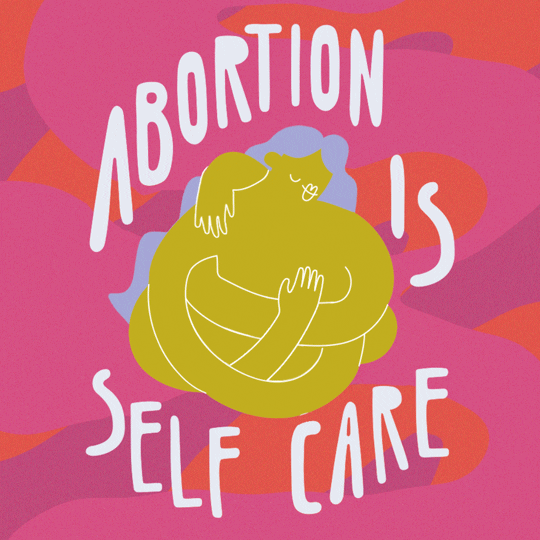 Digital art gif. Line drawing of an abstraction of a woman with wavy lavender hair hugging herself in front of a bold pink and orange color blocked curves. Text in tall white lettering, "Abortion is self care."