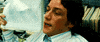 Movie gif. James McAvoy as Wesley Gibson in Wanted leans back onto his desk. He is glistening with sweat and pants heavily. He fans himself with a stack of papers.