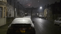 Snow Flurries Cover London at Night