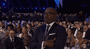 Celebrity gif. Courtney B Vance standing up at Screen Actors Guild awards show, listening while giving an affirmative fist bump.