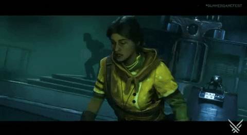Video game gif. A distressed woman in a yellow spacesuit stands up in a dimly lit, industrial environment.