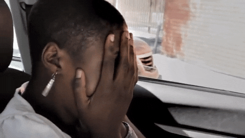 TV gif. Issa Rae as J in Awkward Black Girl sits in a car while she nervously covers her face with both hands before daring to take a peek outside.