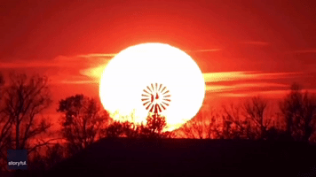 Photographer Captures Perfect Countryside Scene as Minnesota Sun Sets Behind Spinning Windmill